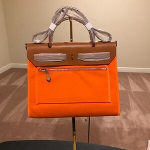 Orange and Brown Handbag, comes with wristlet, lock and key. Size 30, length 25